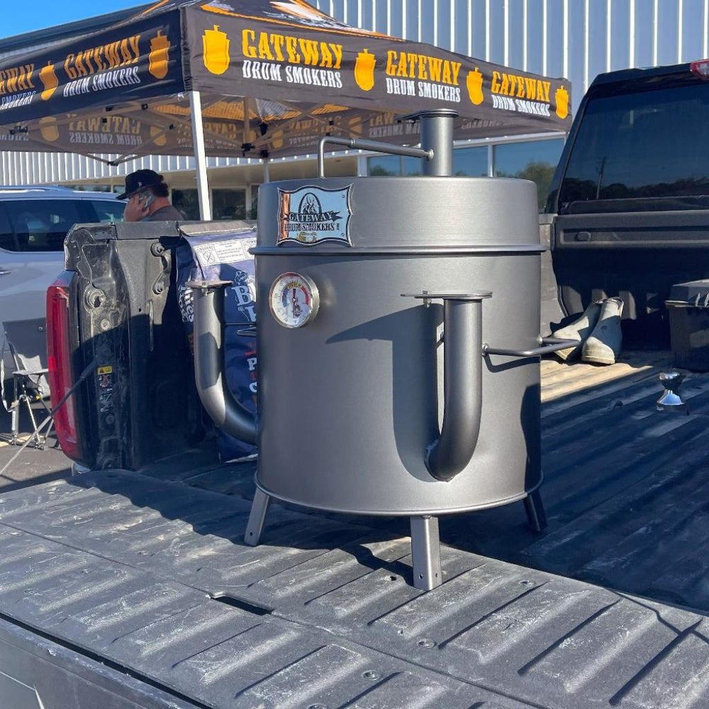 Gateway Drum Smoker & Grills Mini Go2 Charcoal BBQ Smoker in matte charcoal, featuring an elevated hinged lid and dual air intake pipes