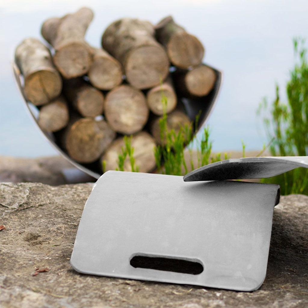 Modern stainless steel log rack with curved Wings of Flight design for stylish firewood storage