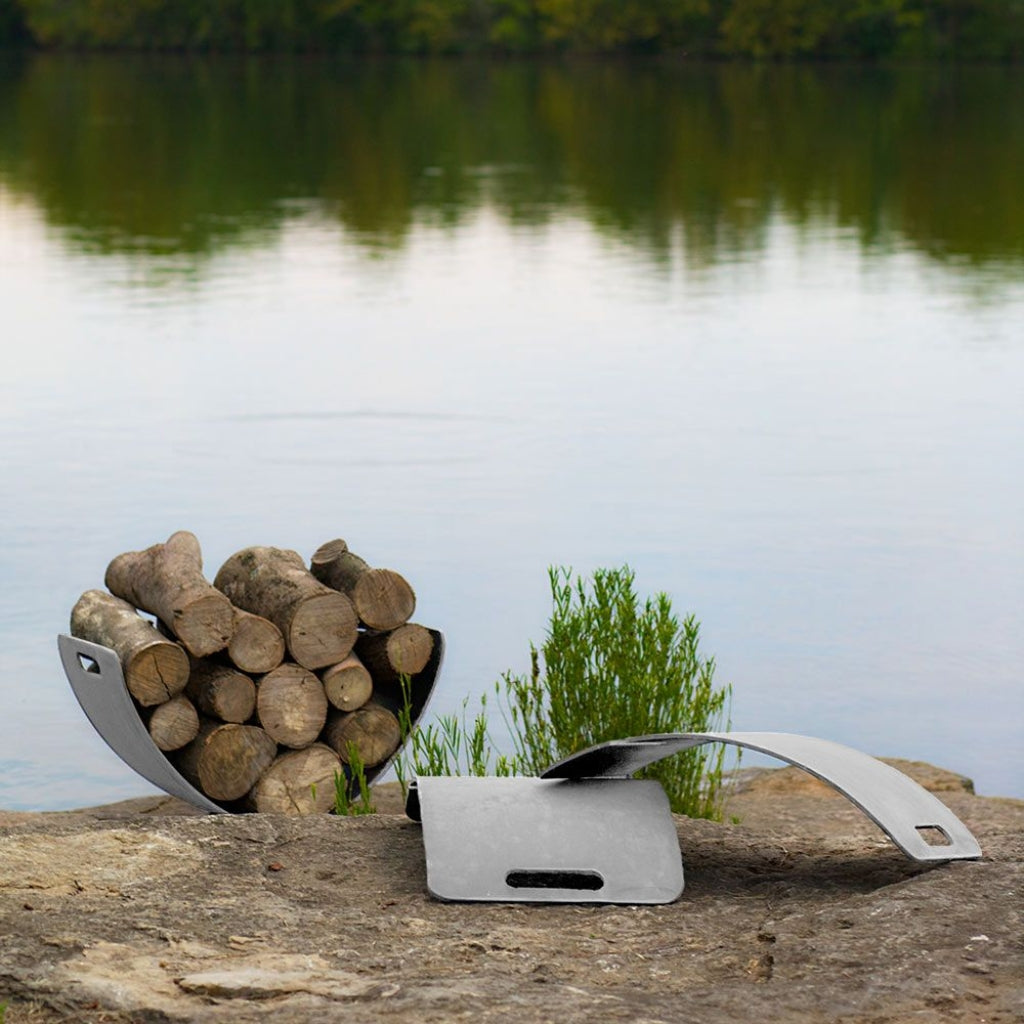 Modern stainless steel log rack with curved Wings of Flight design for stylish firewood storage